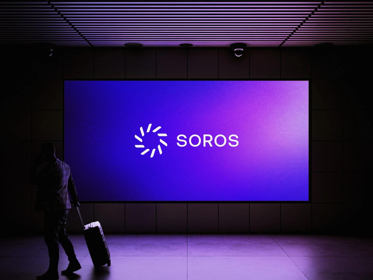 SOROS wordmark on a purple display, with a silhouetted traveler at left